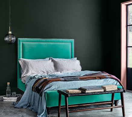 Craig & Rose paints Angelica dark green bedroom with green velvet bed.