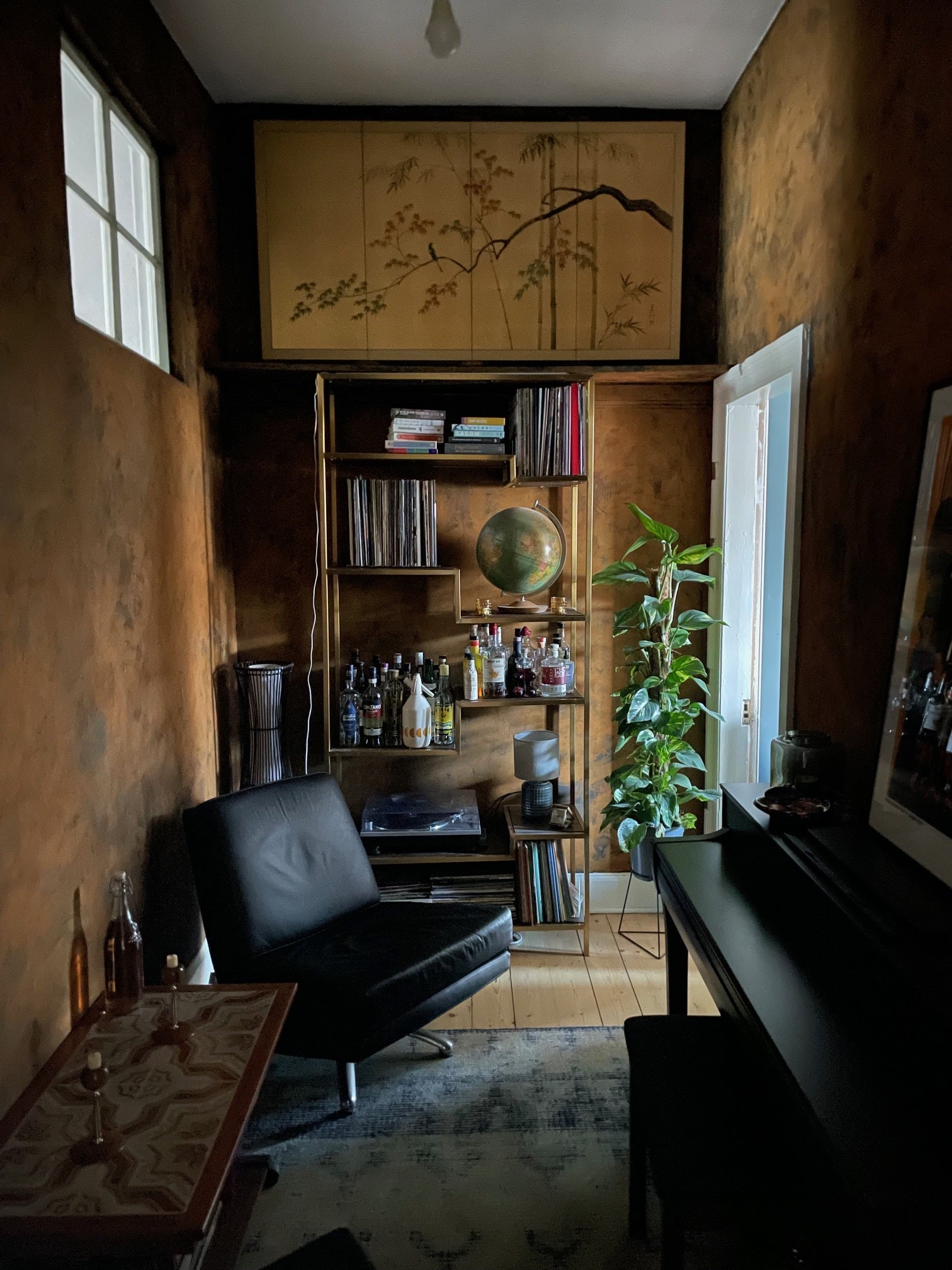 Craig & Rose Artisan Rust Effect Paint and Rust Activator Solution in a small study with gold bookcase.